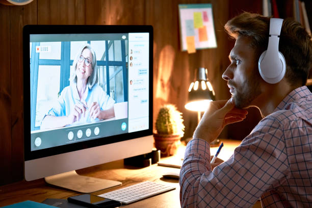 istock Serious male student wearing headphones taking online course training, watching webinar, remote university class, virtual learning with social distance web teacher, tutor or coach using computer. 1286802143