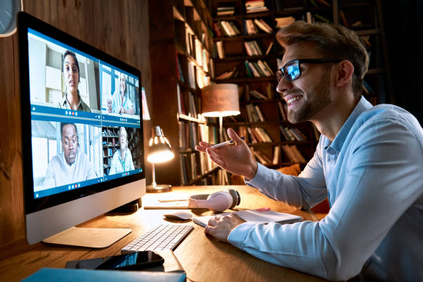 istock Business man having virtual team meeting on video conference call using computer. Social distance worker working from home office talking to diverse colleagues in remote videoconference online chat. 1286802147