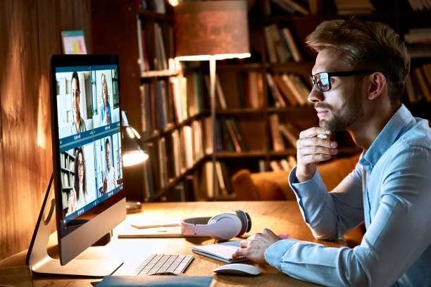 istock Business man meeting virtual team on video conference call using computer. Social distance worker working from home office in remote videoconference online chat, watching webinar, making videocall. 1286802149