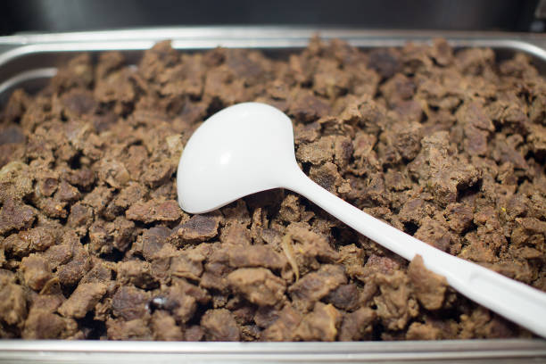 A view of a metal pans full of frozen beef slices, seen at a local Mongolian BBQ restaurant.