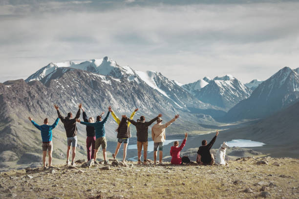 istock Big group of happy hikers in mountains 1286805595