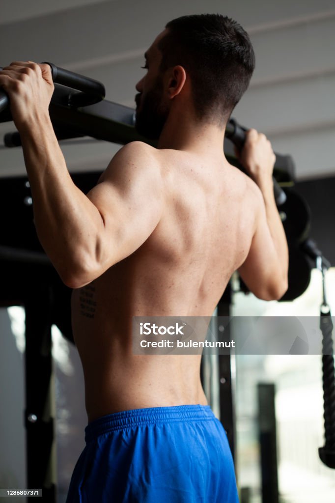 man running bodybuilding by lifting weights Deltoid Stock Photo