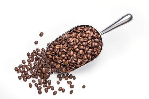 istock Spoon Coffee scoop and coffee beans roasted on a white background 1286808217