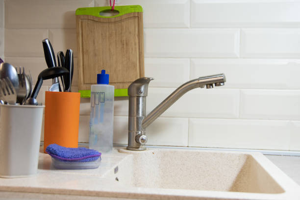istock Empty sink. Preparation for washing dishes front view. Clean forks, knives and spoons stand in a stand container. Homework 1286810659