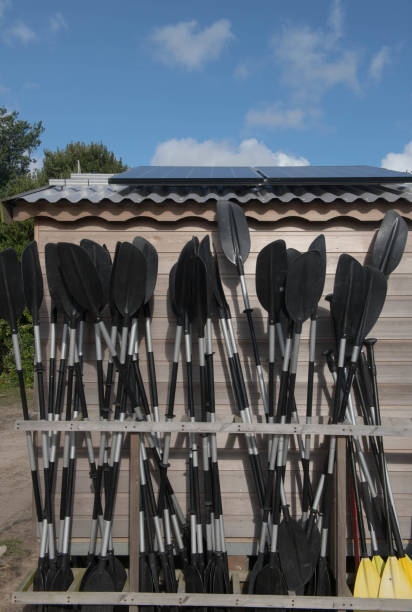 Kayak  and Paddleboard Paddles Stored in a Rack on the Outside of a Solar Powered Beach Hut on the Island of Bryher in the Isles of Scilly, England, UK The Isles of Scilly are an Archipelago off the Coast of Cornwall with 5 Inhabited Islands. tresco stock pictures, royalty-free photos & images