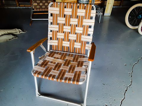 Vintage metal folding lawn chair in classic 70s colors