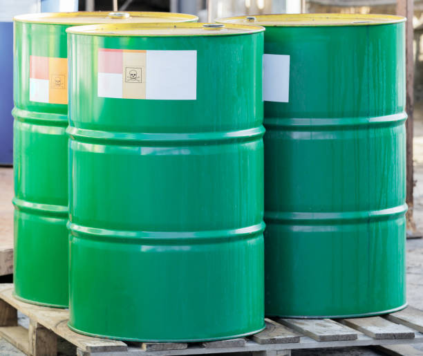 istock Three green barrels with label on wooden pallets 1286811954