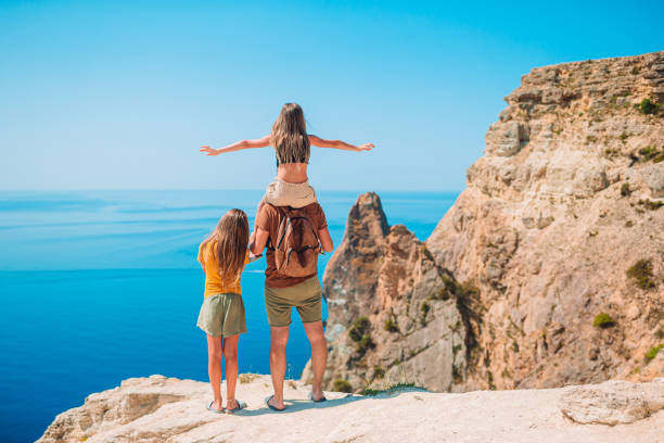 istock Happy beautiful family on a tropical beach vacation 1286812167