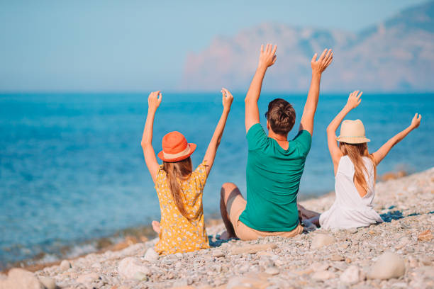 istock Happy beautiful family on a tropical beach vacation 1286812211