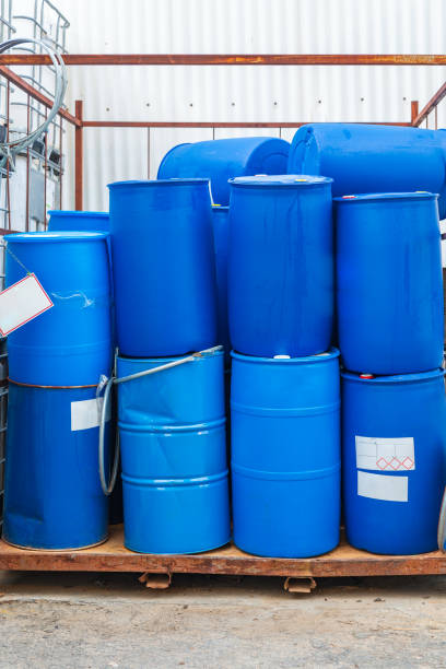istock Used blue barrels on rusted metal pallets 1286812220