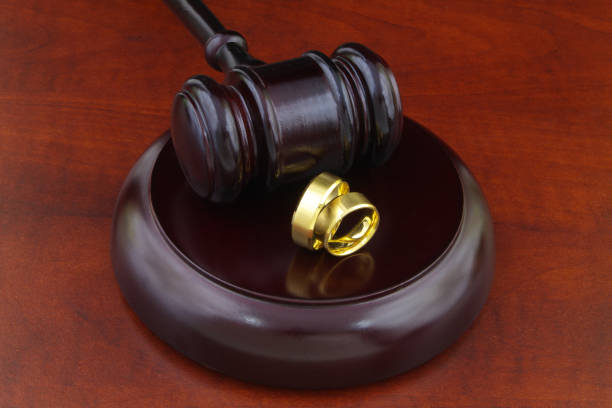 istock Two wedding rings and wooden judge gavel 1286813975