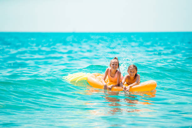 istock Adorable little girls having fun on the beach 1286814985