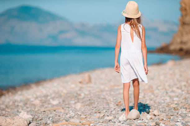 istock Adorable little girl at beach during summer vacation 1286815216