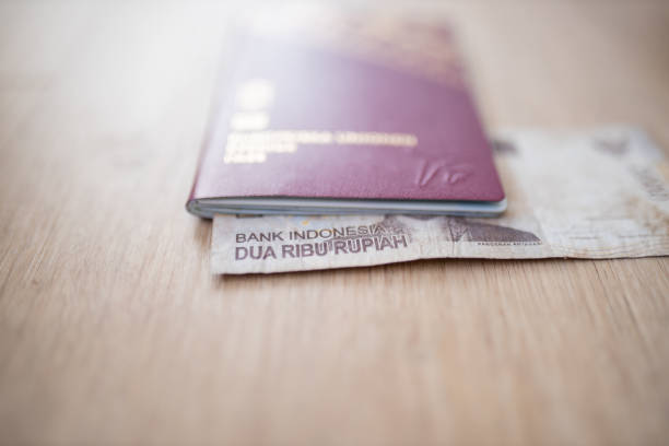 istock Two Thousand Indonesian Rupees Bill Partially Inside a Sweden Passport 1286815364