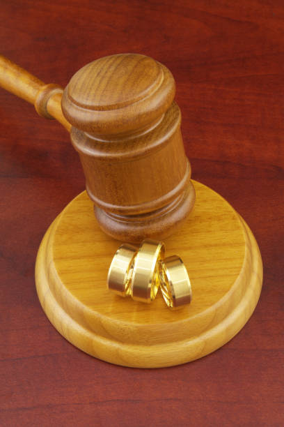istock Two wedding rings and wooden judge gavel 1286815429