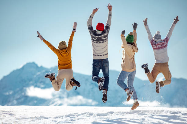 Friends celebrates beginning of winter in mountains Friends celebrates beginning of winter in mountains, jumps and having fun winter sport stock pictures, royalty-free photos & images