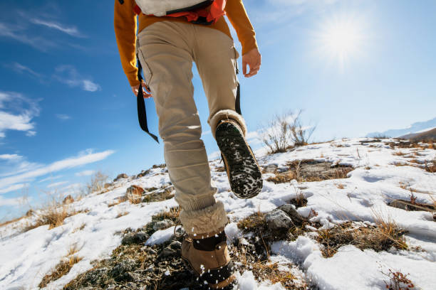 istock Lady hiker goes uphill at snowy surface 1286815998