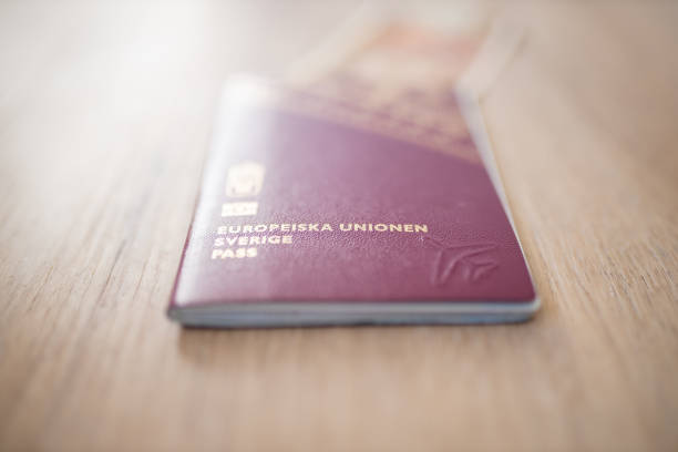 istock Sweden Passport with Fifty Burmese Kyats Bill Partially Inside 1286816358