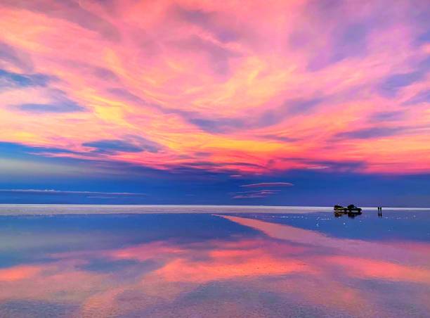 istock Magical sunset, fairytale twilight, colorful sun setting, spectacular cloudscape, alien landscape, breathtaking view, stunning seascape, vibrant pink clouds reflection in the tranquil water. 1286817081