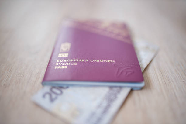 istock Sweden Passport with a Two Thousand Rupees Bill Partially Inside 1286817106