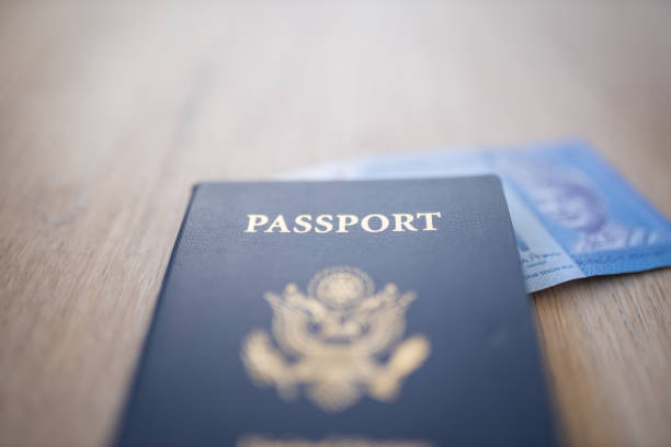 istock United States of America Passport with a One Ringgit Note Inside 1286817215