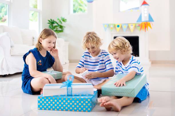 istock Space theme kids birthday party. Boy with present. 1286818081