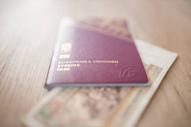 istock Sweden Passport with a Blurry Fifty Burmese Kyats Bill Partially Inside 1286818098
