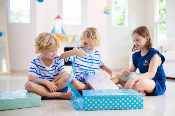 istock Space theme kids birthday party. Boy with present. 1286818120