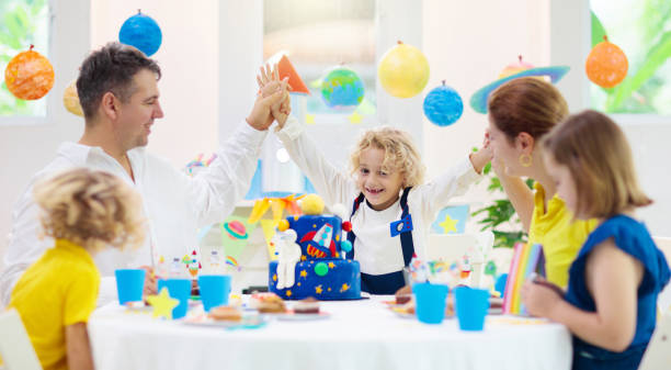 istock Kids space theme birthday party with cake. 1286818173