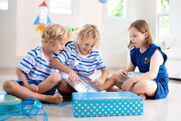 istock Space theme kids birthday party. Boy with present. 1286818237