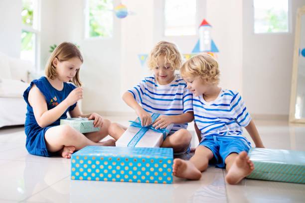 istock Space theme kids birthday party. Boy with present. 1286818265