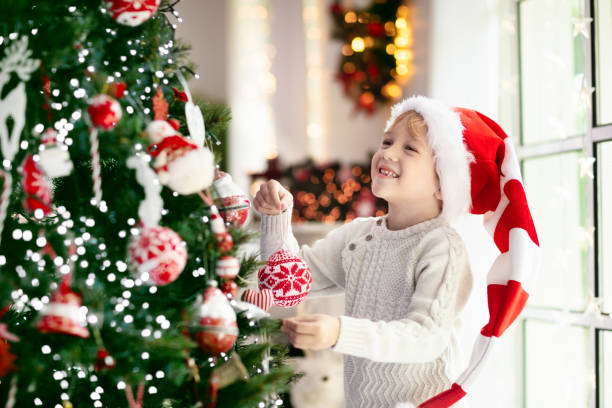 istock Child decorating Christmas tree. Kid on Xmas eve. 1286821030