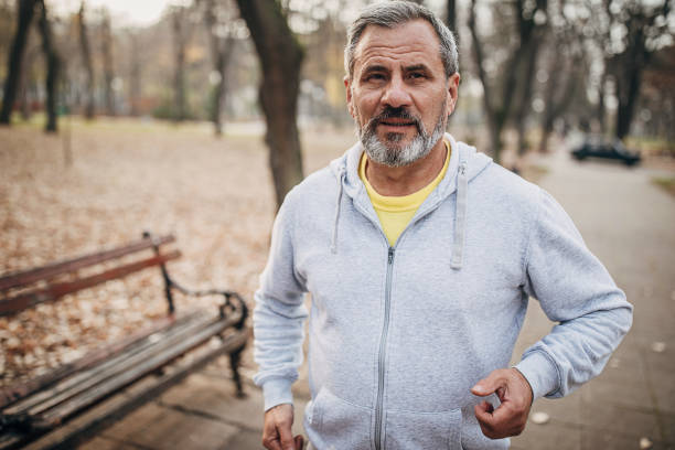 istock Morning jogging of an elderly man in a public park 1286822247