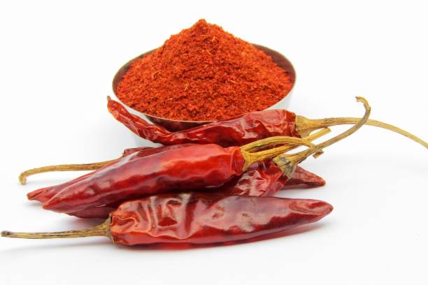 istock Red chili pepper with powder on white background 1286825638