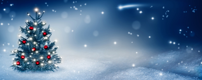 Front view of a group of christmas ornaments such as pine twigs, christmas balls, wooden star shapes and berries standing on the snow with copy space on black background