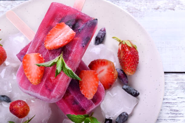 istock Berry popsicles with pieces of strawberry and honeysuckle 1286829680