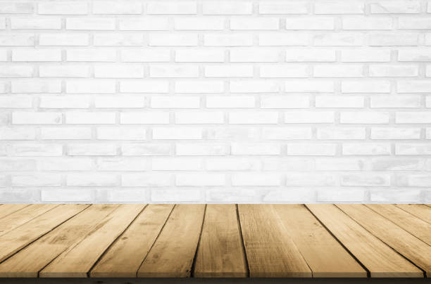 istock Empty wooden table top on white brick wall background, Design wood terrace white. Perspective for show space for your copy and branding. Can be used as product display montage. Vintage style concept. 1286831700
