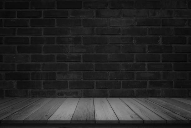 istock Empty wooden table top on black dark brick wall background, Design wood counter white. Perspective for show space for your copy and branding. Can be used as product display montage. Vintage style. 1286831701