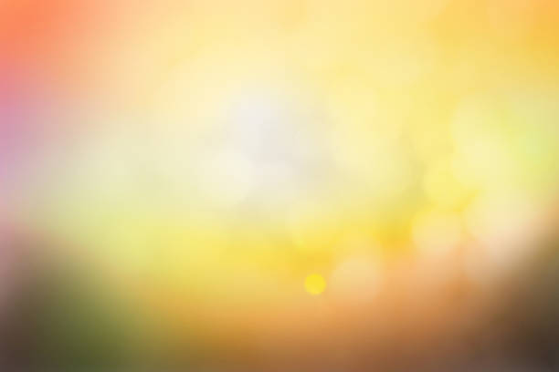 Hope concept; Abstract blurred sunrise background blurring warm colors calm bright sunlight. Sky effect gradient white sun at color orange light yellow soft flare patterns blur plain morning summer.