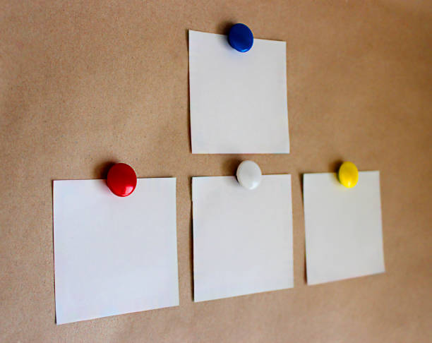 istock four white sheets of paper with magnets 1286833509
