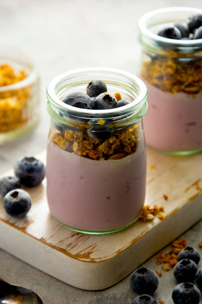 istock Healthy breakfast. Yogurt jars with granola and fresh blueberries. Copy space. 1286836575