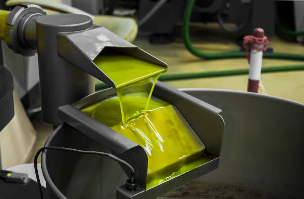 the final phase of extra virgin olive oil production with modern equipment - virgin olive oil imagens e fotografias de stock