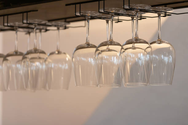 istock wine glass hang on steel bar rack in kitchen room. 1286837231