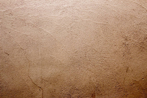 istock Beige colored abstract wall texture background in different shades of cream or beige 1286838742