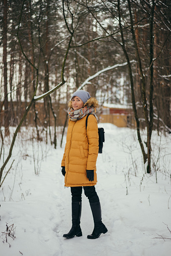 Portrait of a happy woman in a winter forest