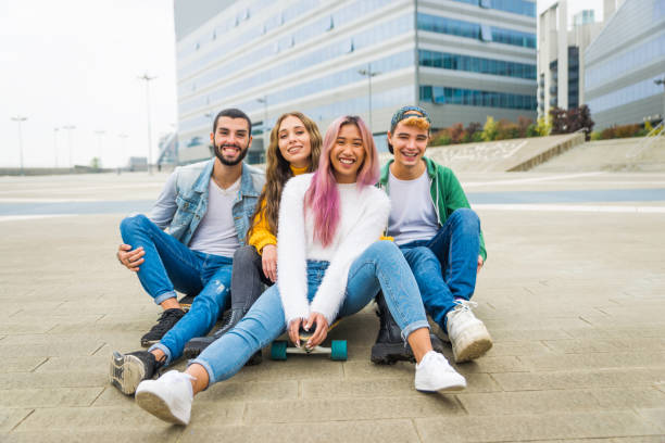 istock Group of young students bonding outdoors 1286842496