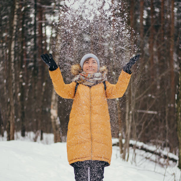 istock Woman throwing snow in the air 1286842540