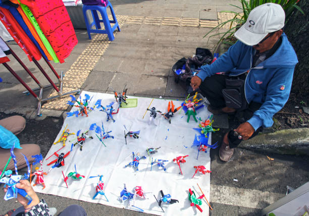 Bandung, West Java, Indonesia - December 11, 2016. Car Free Day is held every Sunday morning at the upper end of Jalan Buah Batu in the city of Bandung. Plastic action figures for sale.