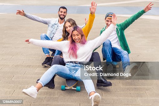 istock Group of young students bonding outdoors 1286843007