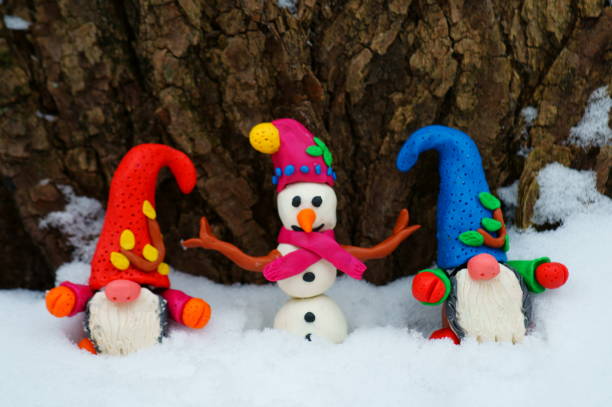 istock Snowman and dwarf figures in the winter forest. 1286843065